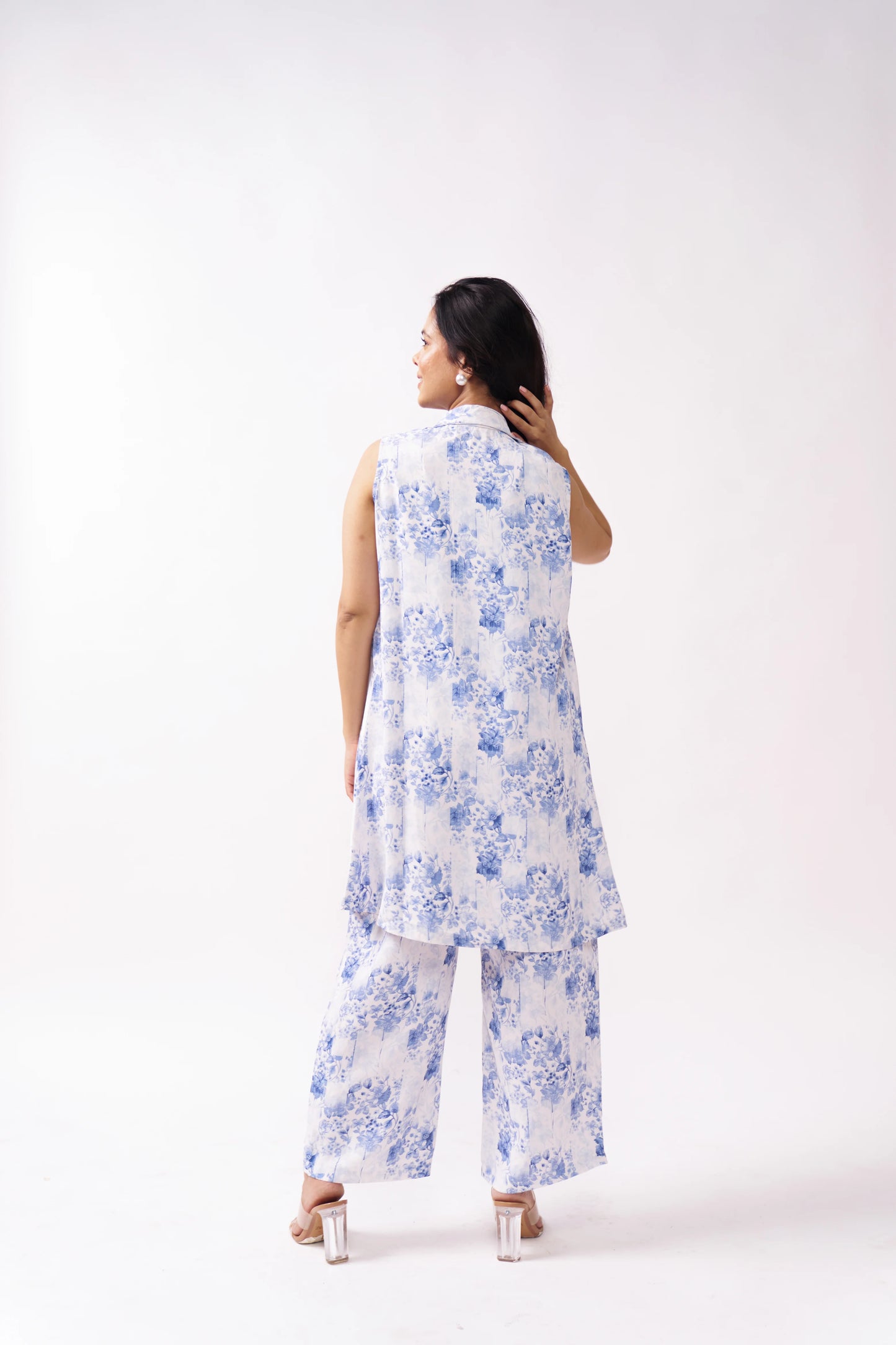 Woman wearing a white floral outfit on a white background