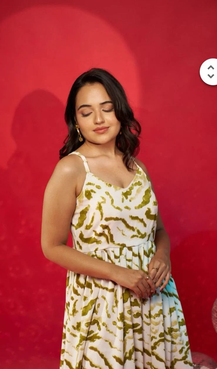Woman wearing a patterned dress against a red background
