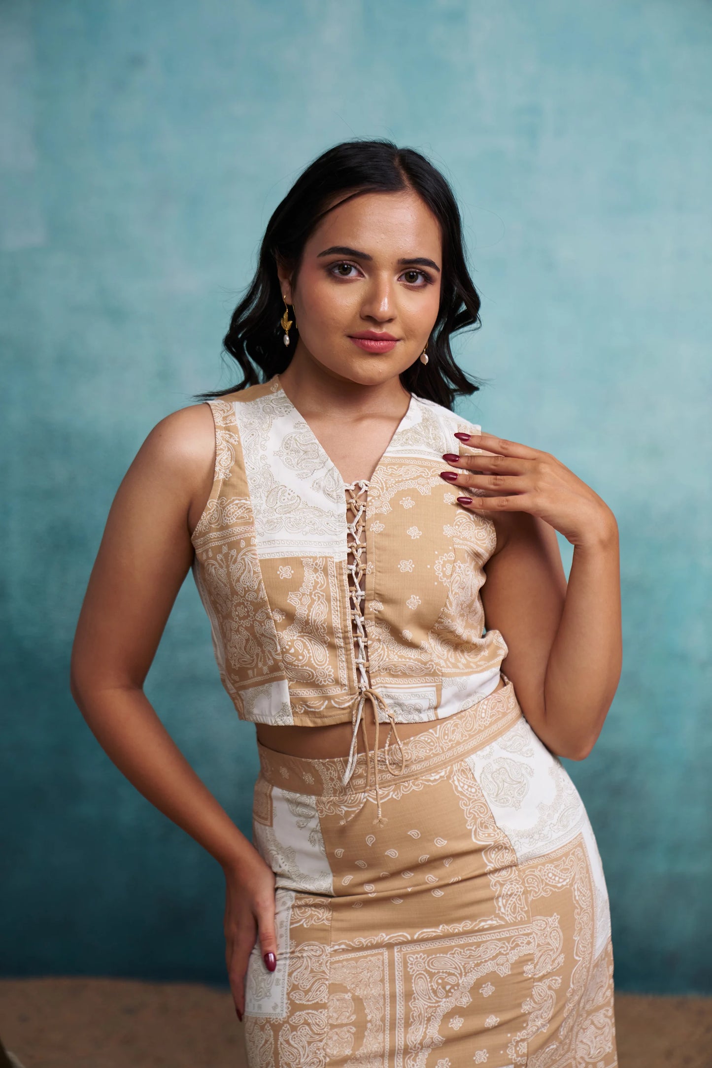 Woman wearing a patterned dress against a blue background