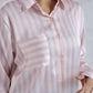 Pink and white striped shirt worn by a person on a plain background