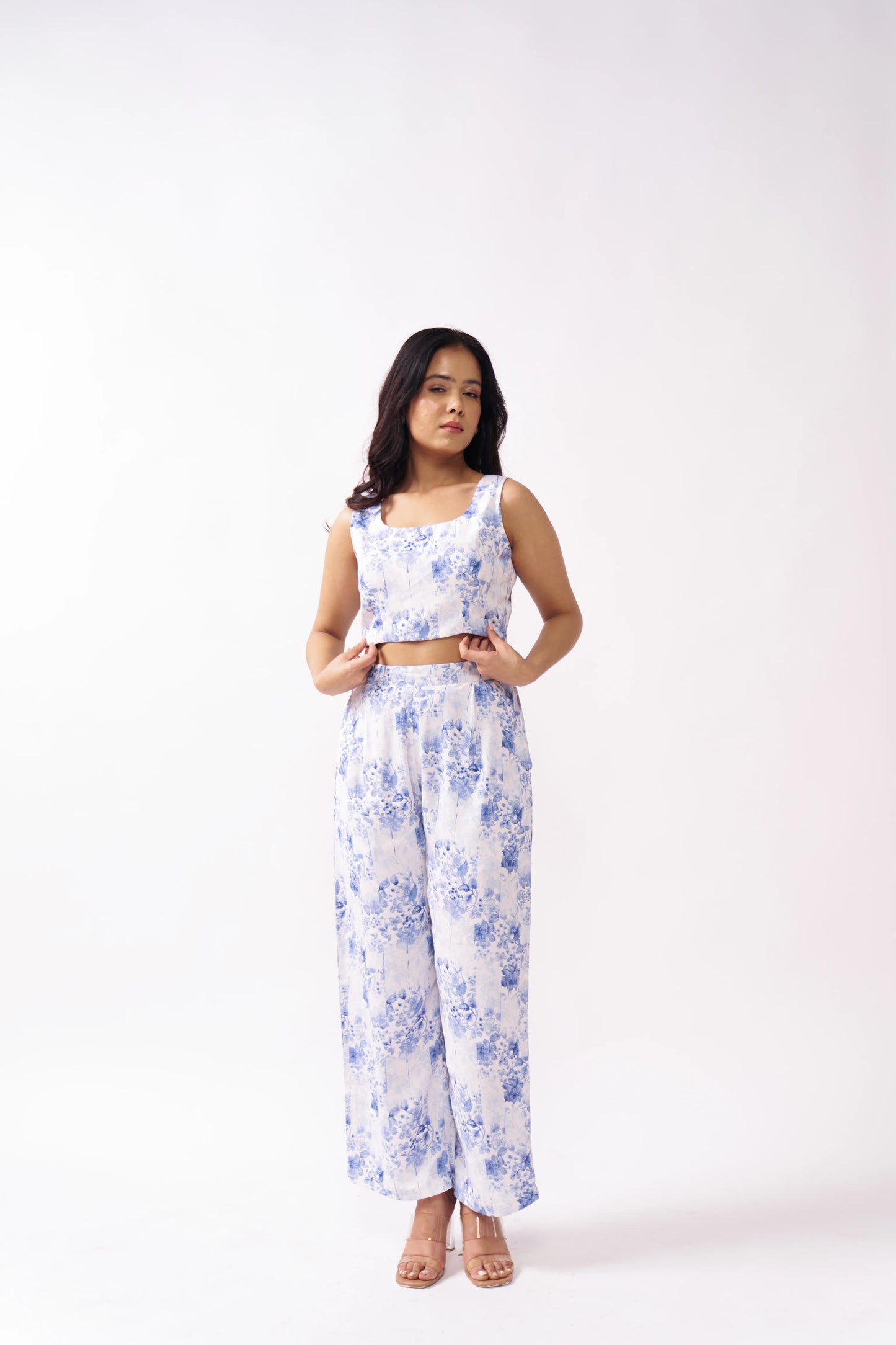 Woman wearing a floral outfit on a white background