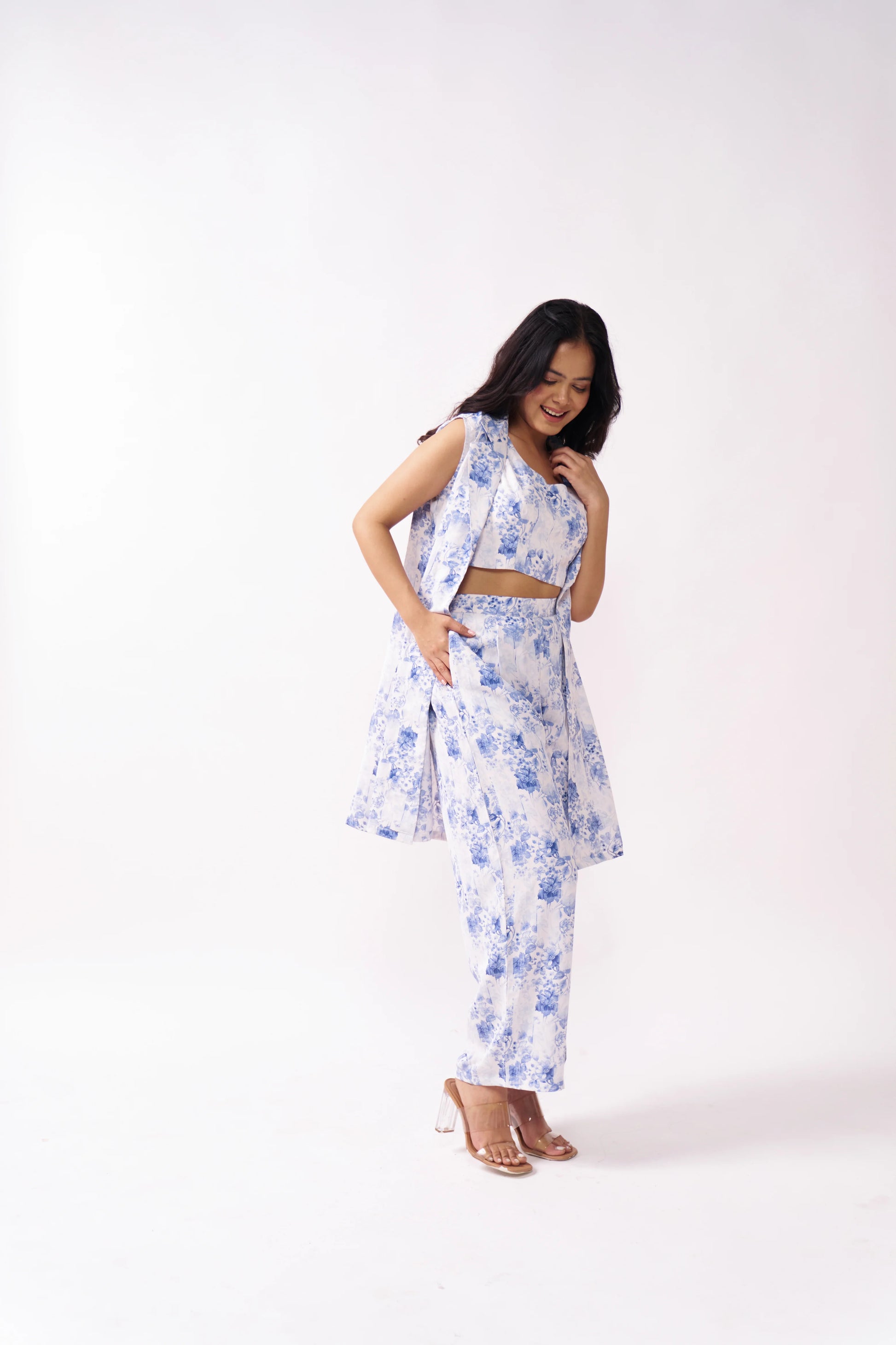 Woman wearing a floral outfit on a white background