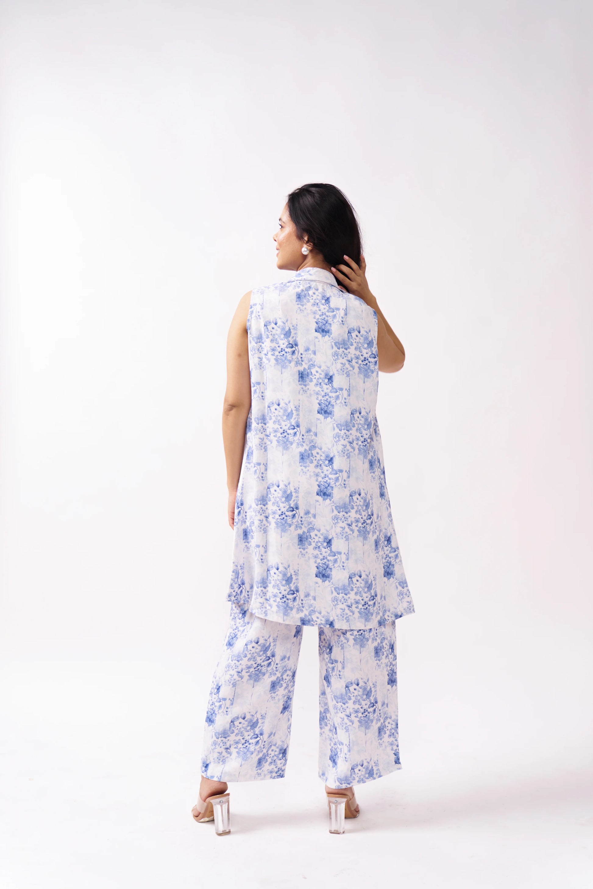 Woman wearing a white floral outfit on a white background