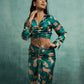 Woman wearing a green patterned outfit against a teal background