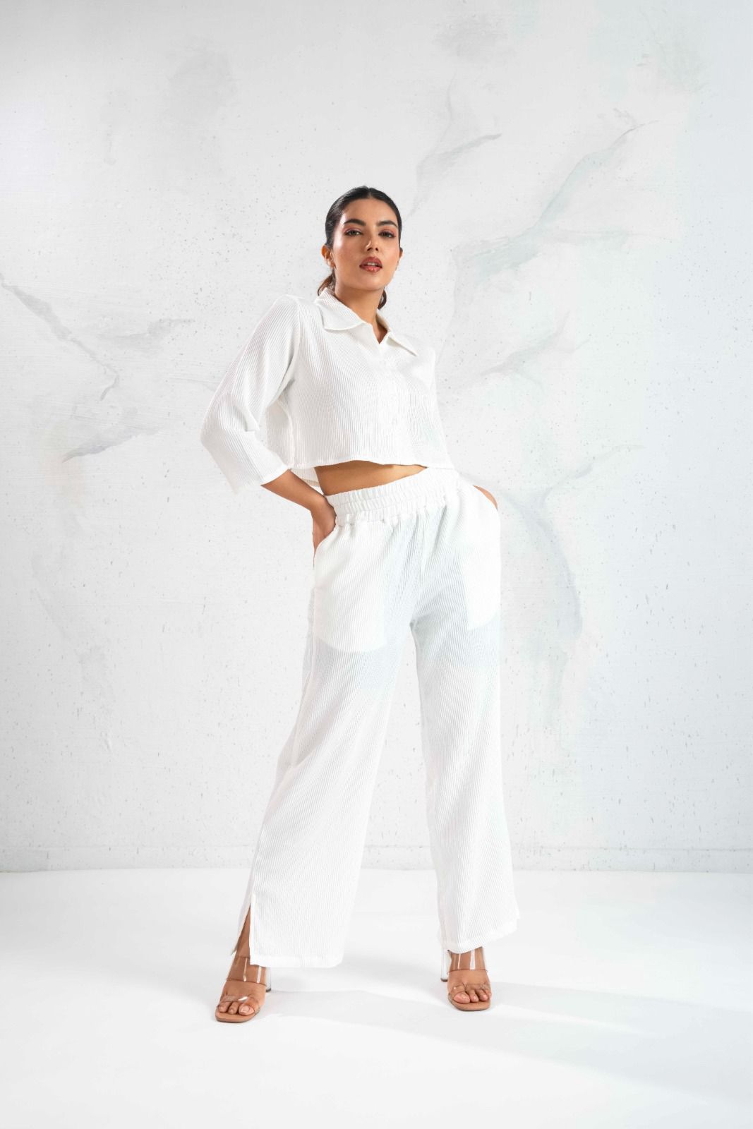 Person wearing a white outfit on a white background