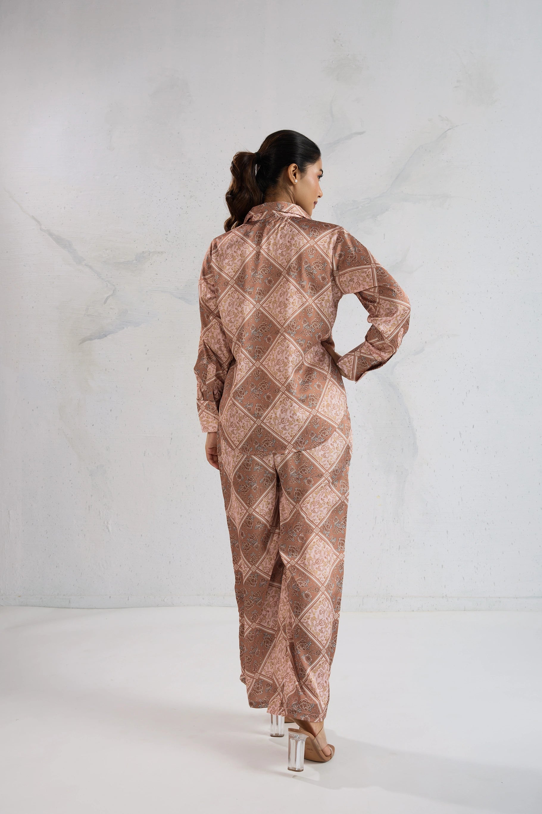 Woman wearing a patterned outfit on a white background