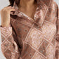 Close-up of a patterned blouse with a neutral background
