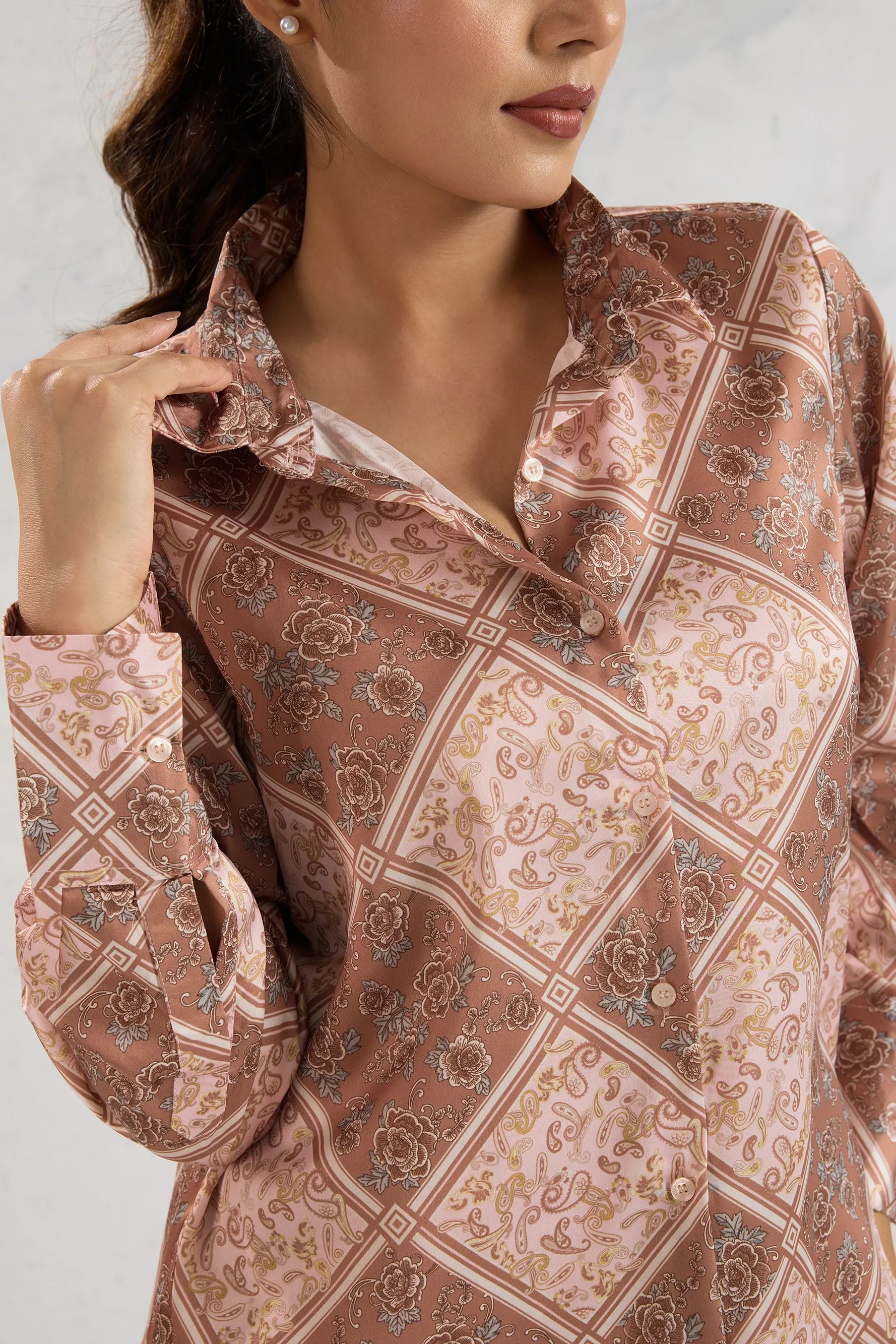 Close-up of a patterned blouse with a neutral background