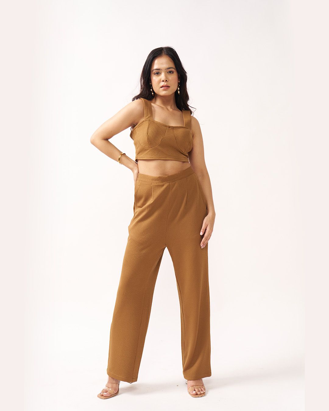 Woman wearing a brown outfit on a white background
