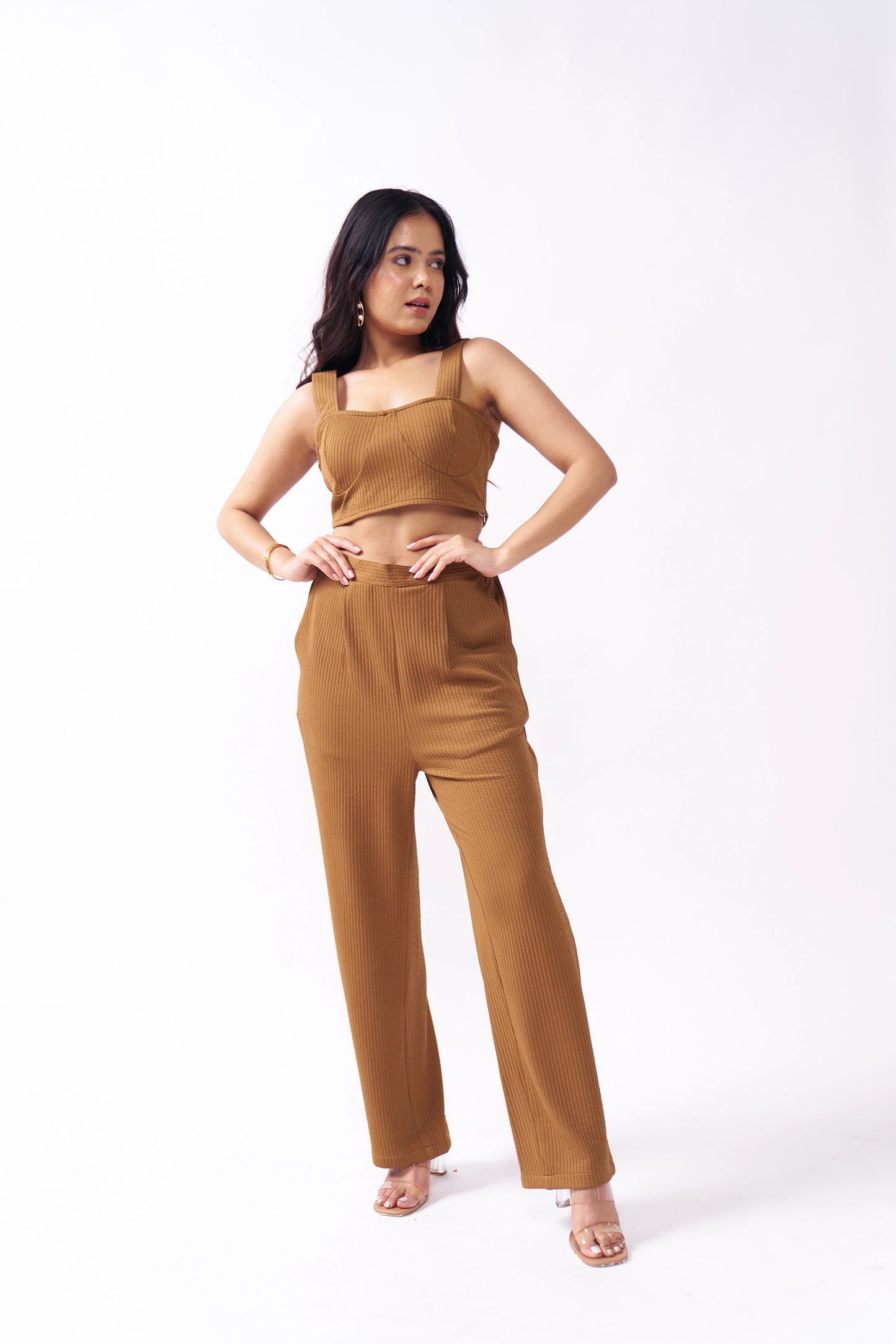 Woman wearing a brown outfit on a white background