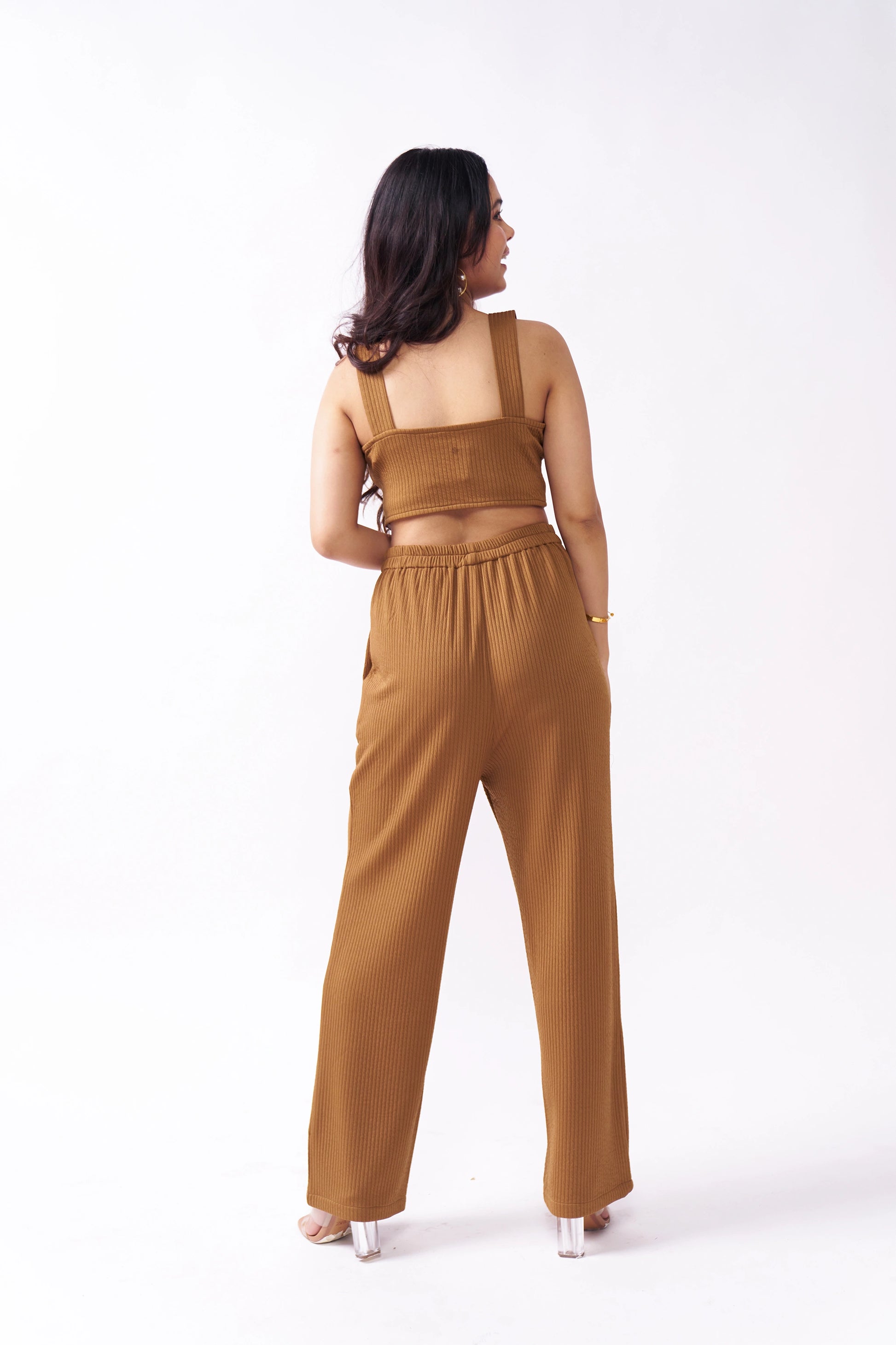 Woman wearing a brown outfit on a white background