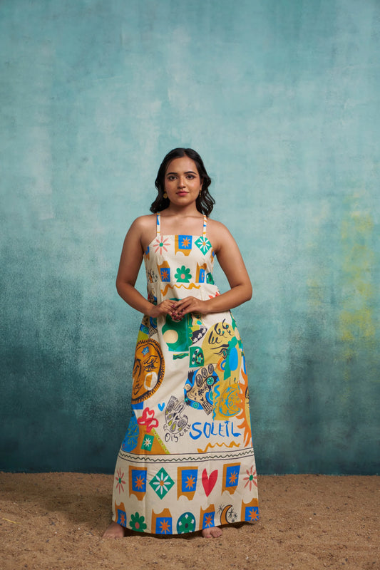 Woman wearing a colorful patterned dress against a textured blue background