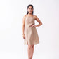 Woman wearing a beige dress on a white background